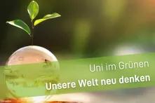 Glasweltkugel mit Pflanze und Schriftzug "Uni im Grünen- Unsere Welt neu denken"